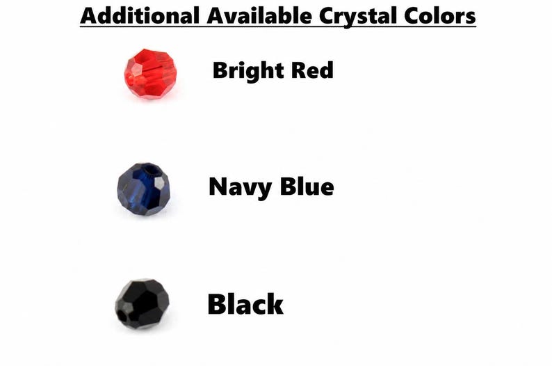 May include: A chart titled Additional Available Crystal Colors displaying three faceted beads. The first is bright red, the second is navy blue, and the third is black. Each bead is labeled with its corresponding color name in bold black text.
