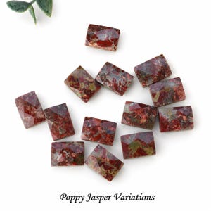 May include: A collection of rectangular, faceted Poppy Jasper gemstones featuring a mottled pattern of deep red, earthy brown, and muted green tones. Each stone displays unique natural inclusions and a polished surface with the text Poppy Jasper Variations.