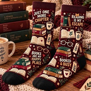May include: A pair of maroon crew socks featuring a repeating pattern of books, coffee mugs, reading glasses, and bookmarks. The text on the socks reads "JUST ONE MORE CHAPTER," "BOOKS ARE MY HAPPY PLACE," "READING IS MY ESCAPE," and "BOOKED & BUSY."