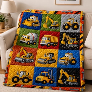 May include: A quilted throw blanket featuring a grid of twelve colorful squares, each displaying a cartoon-style yellow construction vehicle. The border is decorated with a pattern of gray bolts and orange and black caution stripes.