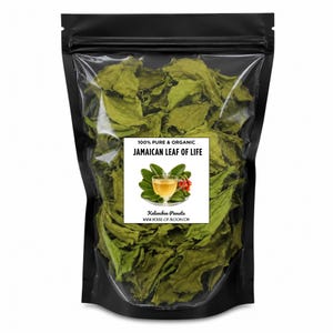 May include: A black bag filled with dried green leaves. A white label displays the text "100% Pure & Organic Jamaican Leaf of Life" with an illustration of a teacup and leaves. The product is from House-of-Bloom.