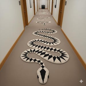 May include: A hallway featuring a series of black and white snake-shaped rugs. The rugs, with a geometric design of black diamonds and triangles on a cream base, create a winding path. The snake's head is at the image's bottom.