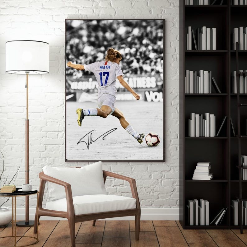 May include: Framed black and white photograph of a soccer player in action, kicking a soccer ball. The player wears a white jersey with the number 17 and the name "Heath". The image is signed and framed.