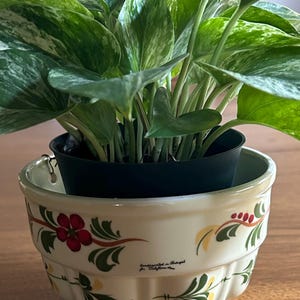 May include: A handmade wooden sign with the text "Welcome" in a handwritten style. The sign is painted white with a distressed finish, and a small, decorative heart is attached. The sign measures approximately 12 inches wide.