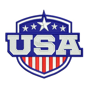 May include: Embroidered USA patch in a shield shape. The design features a blue background with white stars and the word "USA" in white. The bottom portion has red and white stripes, with a white border.