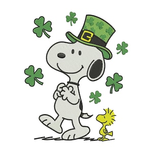 May include: An embroidered image of Snoopy wearing a green leprechaun hat with a gold buckle, surrounded by green shamrocks. Woodstock, the yellow bird, stands beside Snoopy. The design is on a white background, perfect for St. Patrick's Day.
