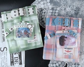 May include: Two rectangular planners featuring plaid covers in green and pink-blue, each adorned with a white buckled strap, a star-shaped charm, and a clear plastic photo holder displaying a printed image of people on the front cover.