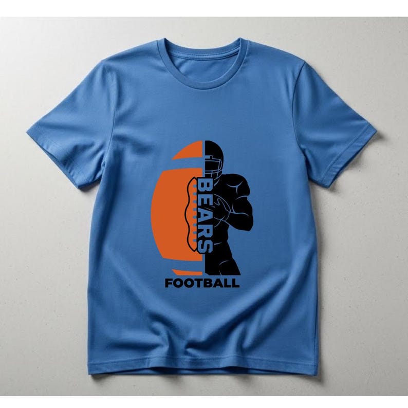 May include: A light blue t-shirt featuring a football design. The design includes an orange football shape with the word "BEARS" in white, and a black silhouette of a football player. The word "FOOTBALL" is printed below the design.