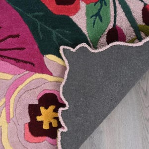 Backing of a handmade floral rug showing high-quality cotton canvas and artisan craftsmanship
