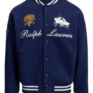 May include: A navy blue varsity jacket with white and navy striped cuffs and collar. The jacket features the embroidered text "Ralph Lauren" in white script, along with a crest and a polo player logo.