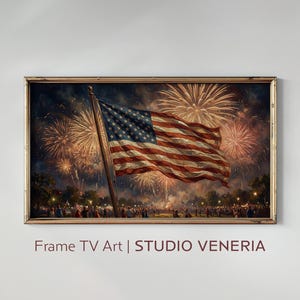 May include: A rectangular framed wall art piece featuring a digital illustration of the American flag waving against a night sky filled with golden fireworks. Below the flag, a crowd of people stands in a park-like setting under the display.