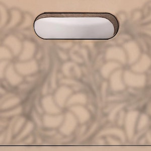 May include: A tan leather tote bag with a floral pattern and a rectangular handle opening. The bag has a stitched border and a simple, elegant design, suitable for everyday use.