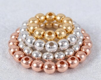 100 cuentas de oro y plata auténticas bañadas en cobre: cuentas redondas hipoalergénicas, resistentes a la decoloración y a la oxidación, ideales para hacer joyas y abalorios.
