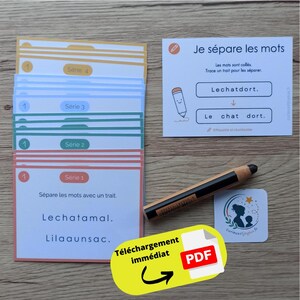 May include: A stack of educational cards with colored borders labeled Serie 1 through 4, a white instruction card titled Je sépare les mots, a black marker, and a small square logo card. The cards feature French text exercises for separating words.