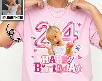May include: A light pink t-shirt featuring a custom graphic with the number 24 in metallic pink balloon-style font, a photograph of a child holding an ice cream cone, and the text Happy Birthday in pink glittery letters, accented with stars.