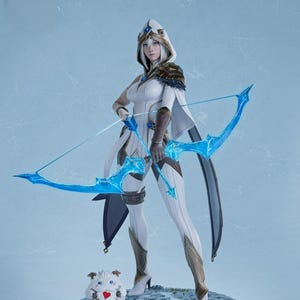 May include: A detailed figurine of a character in a white and gold outfit, holding a blue bow. The figure stands on a stone base with a small, fluffy creature with a heart on its chest. The character has a hood and cape.
