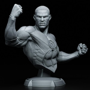 May include: A gray bust of a muscular superhero with a determined expression, clenched fists, and a Green Lantern emblem on the chest. The sculpture is detailed, with textured clothing and a round base, set against a black background.
