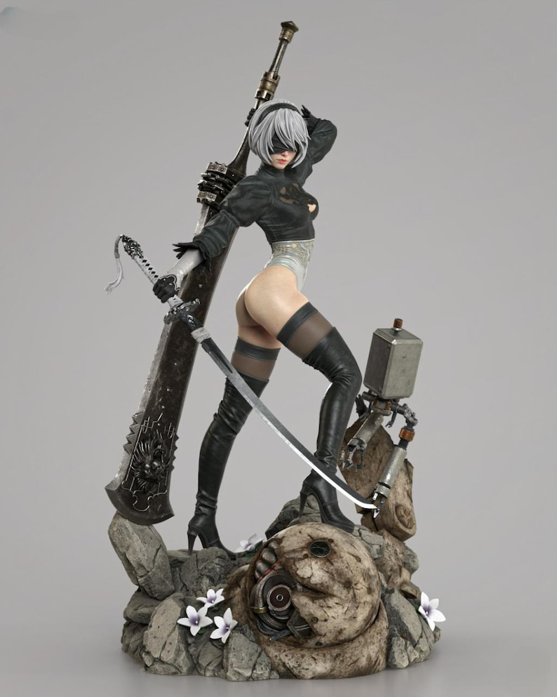 May include: A detailed figurine of a character with short white hair and a black blindfold, wearing a black long-sleeved top, white leotard, and black thigh-high boots. The figure holds a long sword and stands on a rocky base with small white flowers.
