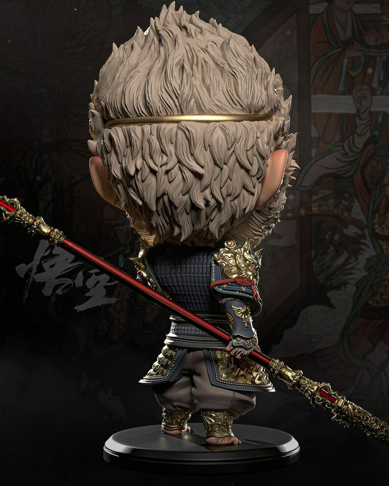 May include: A detailed figurine of a monkey-like character in traditional armor, holding a red and gold staff. The figure has a textured, light-colored fur-like head and is posed on a black base. The armor is detailed with gold accents.