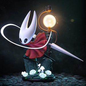 May include: A detailed figurine of a character with a white mask, red cape, and a large, bladed weapon. The figure stands on a base with white roses and mushrooms, illuminated by a glowing orb and a decorative lamp. The background is dark.