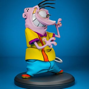 May include: A figurine of the cartoon character Ed from Ed, Edd n Eddy. The figure is posed with a wide grin, wearing a yellow shirt with purple trim, blue pants, and orange shoes. The figure is on a black circular base against a blue background.