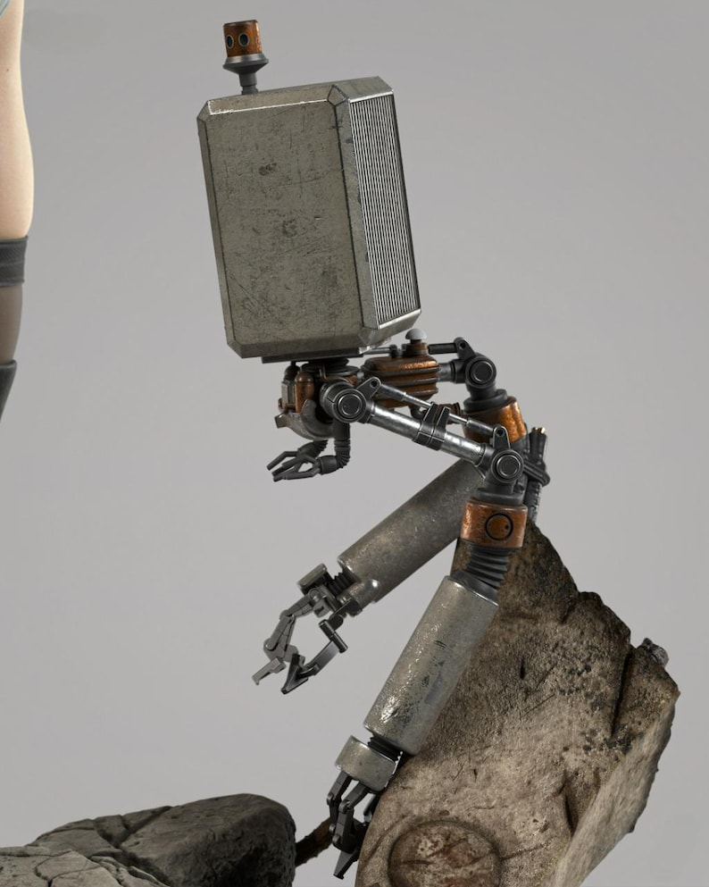 May include: A mechanical robot figure with a rectangular, metallic head featuring a small antenna. The body consists of articulated, weathered silver and copper-toned limbs with claw-like hands, positioned in a seated posture upon a textured rock.