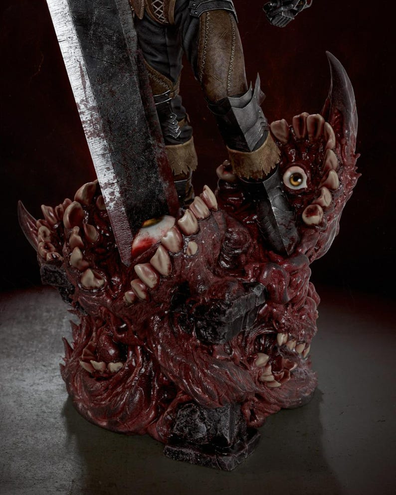 May include: A detailed collectible figurine base featuring a mass of organic, fleshy textures with multiple human-like eyes and rows of sharp teeth. A large, weathered metal sword is embedded into the center of the grotesque, dark red mass.