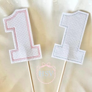 May include: A handmade wooden sign with the text "Welcome" in a playful font. The sign is painted white with a distressed finish, and features a small, decorative heart. Perfect for adding a touch of rustic charm to any home.