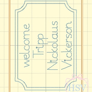 May include: A light blue embroidered design on a cream background. The design features the word "welcome" above the names "Tripp Nickolaus Vickerson" within a decorative frame. A pink and white logo is in the bottom right corner.