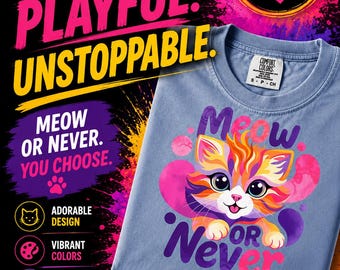 May include: A light blue t-shirt featuring a colorful graphic of a cat with large eyes and the text "Meow or Never". The shirt has a Comfort Colors brand label on the inside collar. The surrounding text includes "Cute. Playful. Unstoppable."