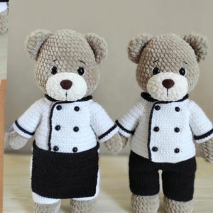 May include: Two handmade crochet teddy bears wearing chef outfits. The bears have light brown fur, white chef coats with black trim and buttons, and black bottoms. One bear wears a black apron. The bears have brown noses and black eyes.