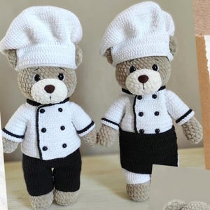 May include: Two crocheted teddy bears dressed as chefs. Each bear wears a white chef's hat, a white jacket with black buttons and trim, and black pants. The bears have brown eyes and noses.