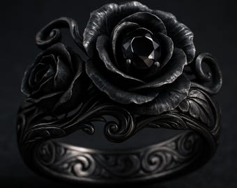 May include: A black ring featuring a rose design. The ring has two sculpted roses with a black gemstone center. The band is detailed with an ornate pattern. The ring is made of a dark metal.