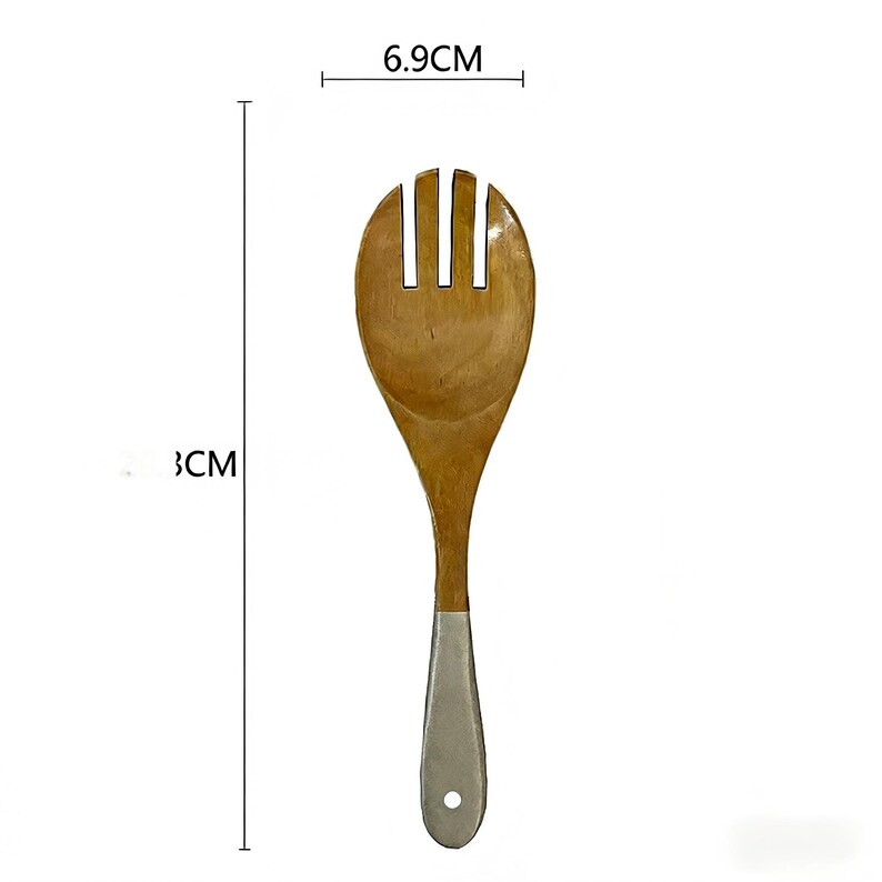 May include: Wooden salad spoon with a light brown finish and a silver-coloured handle. The spoon head is 6.9 cm wide and the spoon is 33 cm long. The spoon has a slotted design, ideal for serving salads.