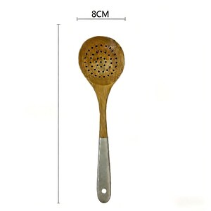 May include: A wooden slotted spoon with a light brown finish. The spoon's head is round, measuring 8cm across, and features numerous small holes. The handle is a natural wood colour, transitioning to a silver-coloured metal at the base.