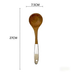 May include: A wooden cooking spoon, 27 cm long, with a 7.5 cm wide bowl. The spoon is made of light brown wood with a handle that has a white and tan accent. The handle has a hole at the end for hanging.