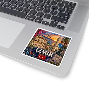 May include: A square sticker featuring a scenic view of Izmir, Turkey, with the city's name and the Turkish flag. The image includes a clock tower, buildings, palm trees, and a sunset over the water. The sticker is on a laptop.