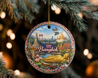May include: A round ceramic ornament featuring a colourful illustration of Thailand and Bangkok landmarks, including a reclining golden Buddha, an elephant, a traditional boat, and temples. The text reads Thailand and Bangkok with a small flag.