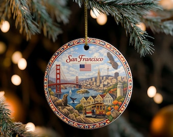 May include: A round ceramic ornament featuring a colourful illustration of San Francisco landmarks including the Golden Gate Bridge, a cable car, and a sea lion. The text San Francisco is printed in red above a small American flag and a flying eagle.