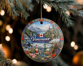 May include: A round ceramic ornament featuring a colourful illustration of Vancouver, Canada. The design includes a lighthouse, a bear, an orca, a totem pole, mountains, and the Canadian flag. The text reads Vancouver Canada in white script.