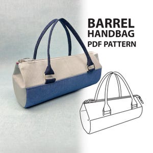 May include: A two-tone barrel handbag with a light grey upper section and a blue denim lower section. It features blue handles and a zip closure. The text "BARREL HANDBAG PDF PATTERN" is displayed in black. A line drawing of the handbag is also shown.