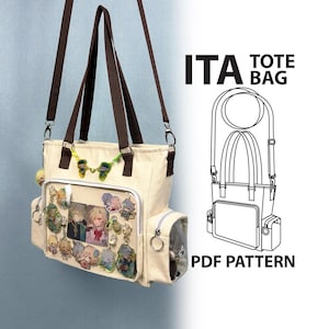 May include: A cream-colored canvas ita tote bag with brown straps, featuring a clear front display pocket filled with various character charms and pins, side pockets, and a line drawing diagram labeled ITA TOTE BAG PDF PATTERN.