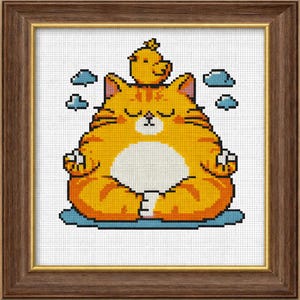 May include: A framed cross-stitch artwork featuring a meditating orange cat with a small yellow bird on its head. The cat is in a lotus position, surrounded by blue cloud motifs. The artwork is in a brown wooden frame.