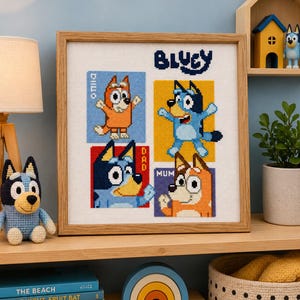 May include: A framed cross-stitch artwork featuring characters from the animated series Bluey. The artwork includes the characters Bingo, Bluey, Dad, and Mum, each in a colorful square. The word "Bluey" is at the top.
