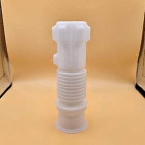 Pu&ograve; includere: Oggetto cilindrico bianco con corpo scanalato e parte superiore strutturata. L'oggetto ha una base svasata e una serie di scanalature orizzontali. Il design &egrave; geometrico e moderno, con un'estetica pulita e minimalista.