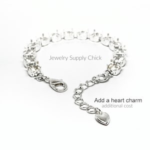May include: Silver bracelet with clear rhinestones and a heart charm. The bracelet has a lobster clasp and an extender chain. "Jewelry Supply Chick" is written on the image. "Add a heart charm additional cost" is also written on the image.