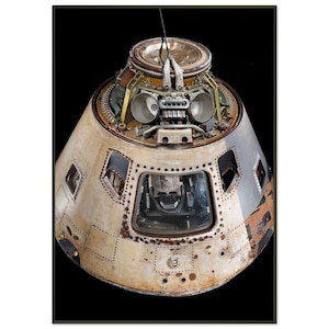 May include: A vintage, weathered spacecraft capsule, featuring a conical shape with visible rivets and multiple windows. The capsule has a metallic exterior with areas of discoloration and rust, set against a black background. The top section reveals intricate internal components.