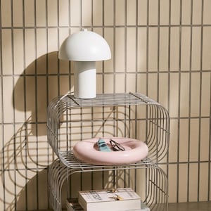 May include: A set of three ceramic mugs with a speckled, matte finish. The mugs are in shades of cream, light gray, and dark gray. Each mug has a simple, minimalist design and a rounded handle. The mugs are suitable for coffee, tea, or other beverages.