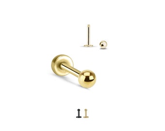 May include: Gold barbell with a small ball on each end. The barbell is a common type of body jewelry used for piercings.