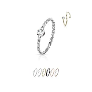 May include: A silver nose ring with a clear stone and a twisted band. The ring is shown in multiple colors, including gold, black, rose gold, and silver.